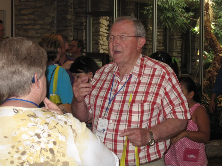 a man standing next to a woman talking