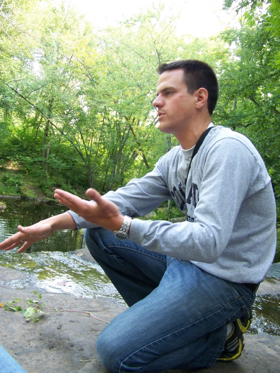 a man sitting down with his hands outstretched