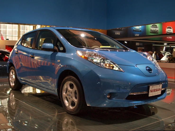 a blue electric car parked in a car showroom