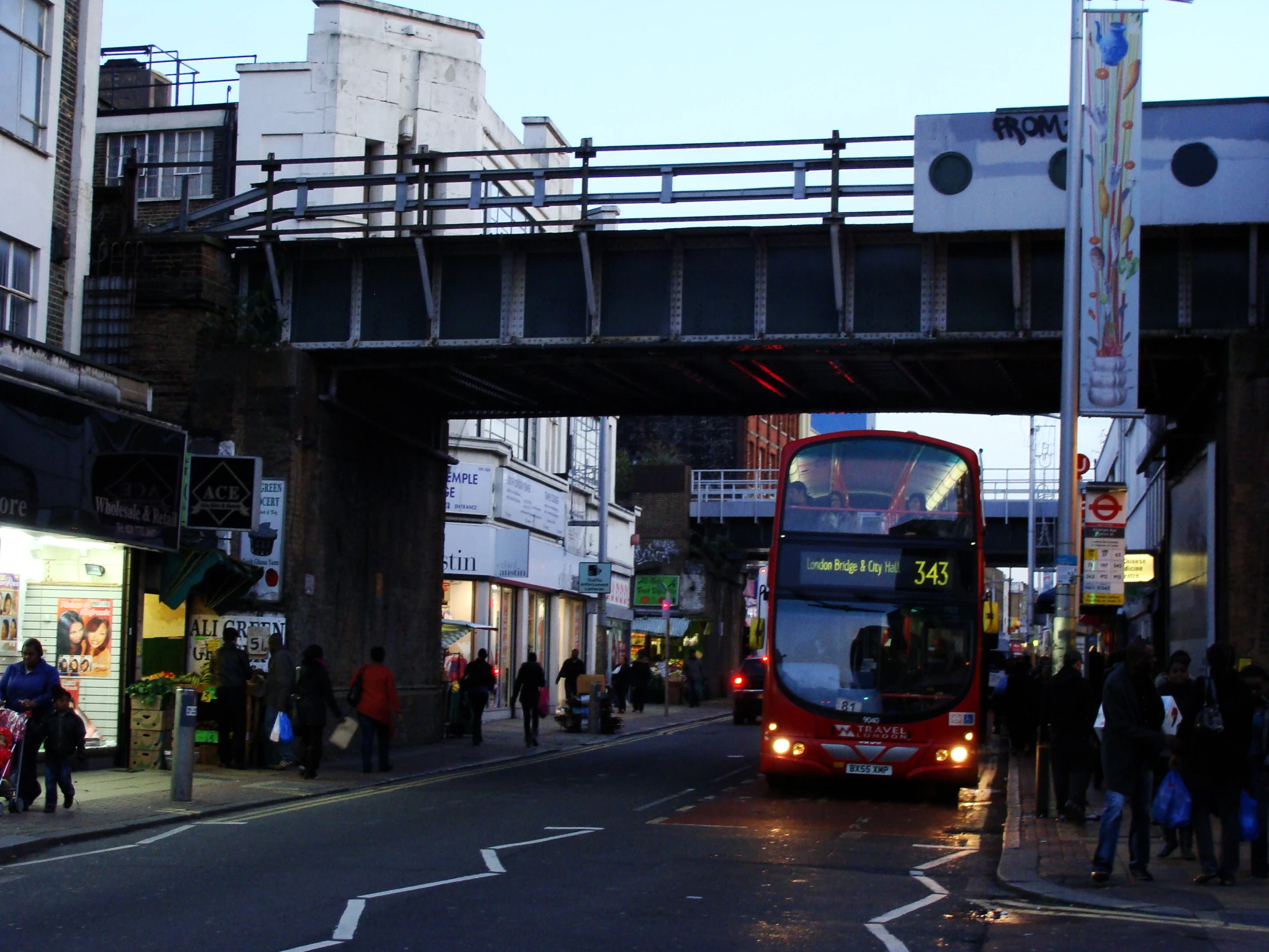 a big red bus going under the road