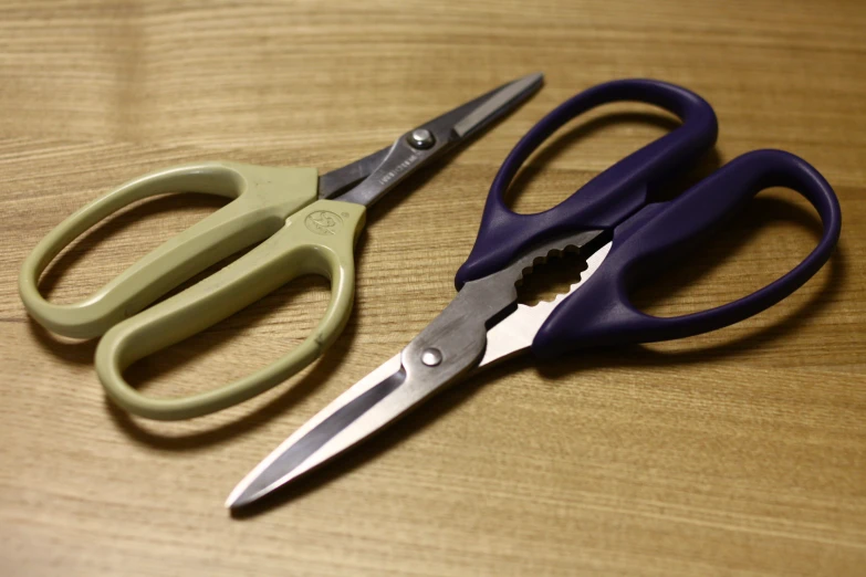 two pairs of scissors, one green and one blue