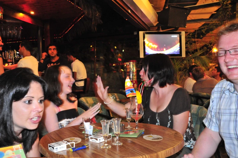 a man and woman are clapping at a table