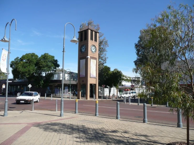 a tall clock tower on the side of a street