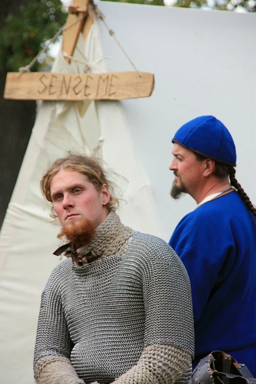 two men in medieval costumes standing beside each other
