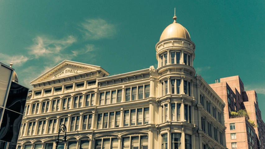 a building on the corner is white and gold