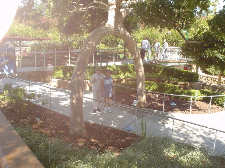 an image of some people standing around on a walkway