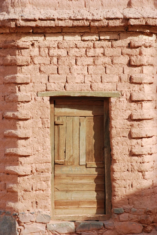 a wooden door sitting between two stone walls