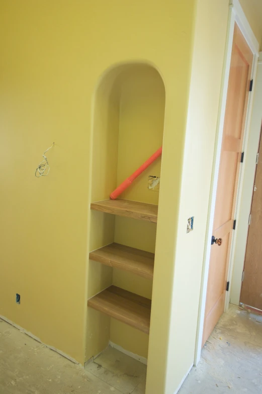 empty shelves are arranged in a room with no furniture