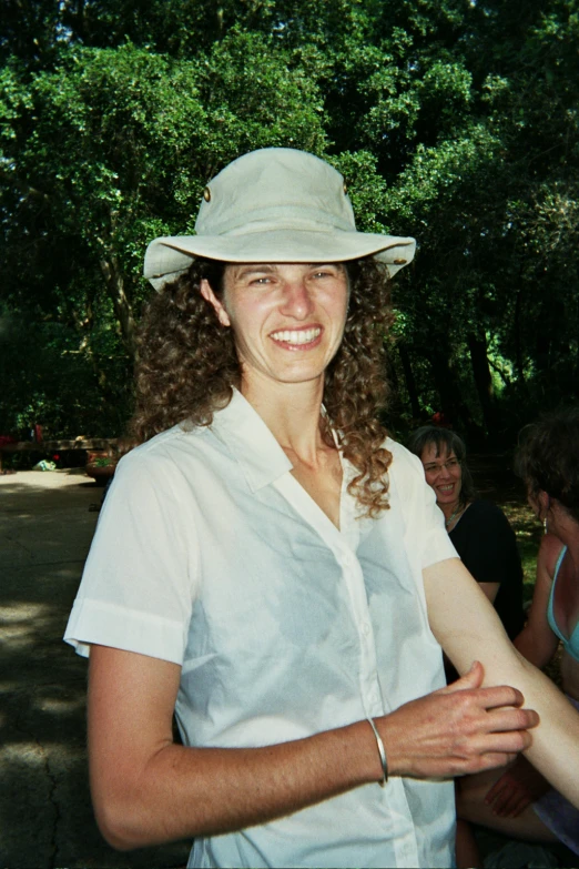 woman wearing an outdoor hat and white shirt