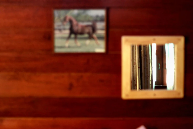 a bedroom with a wooden wall and mirror hanging on it's side