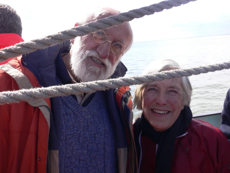 an old man and woman on a boat