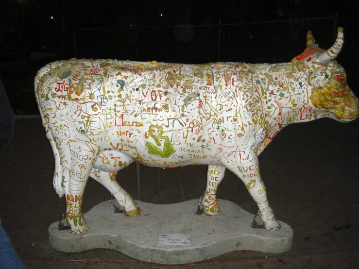a statue of a bull made out of some type of writing