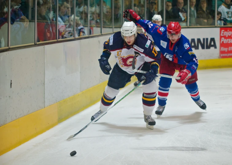 an ice hockey player is going after the ball