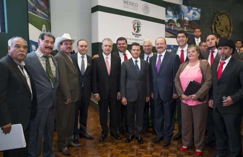 a group of people in suits standing together and posing for the camera