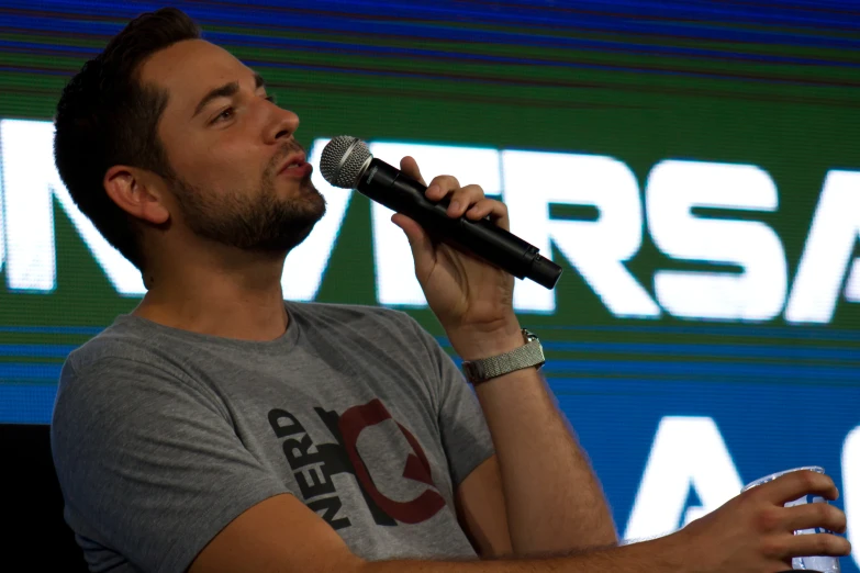 a man holding a microphone up to his mouth
