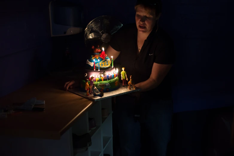 a person is holding a birthday cake with candles in it