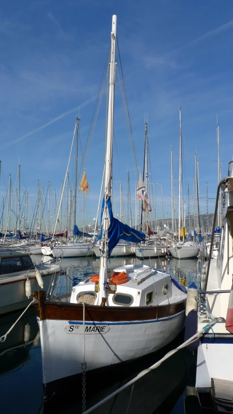 several different boats are docked at the port