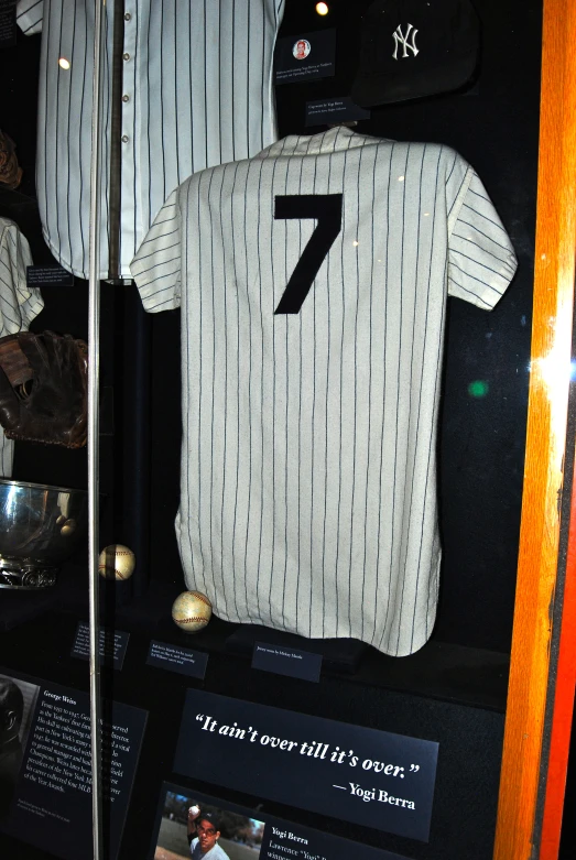 baseball uniforms with a white jersey on display