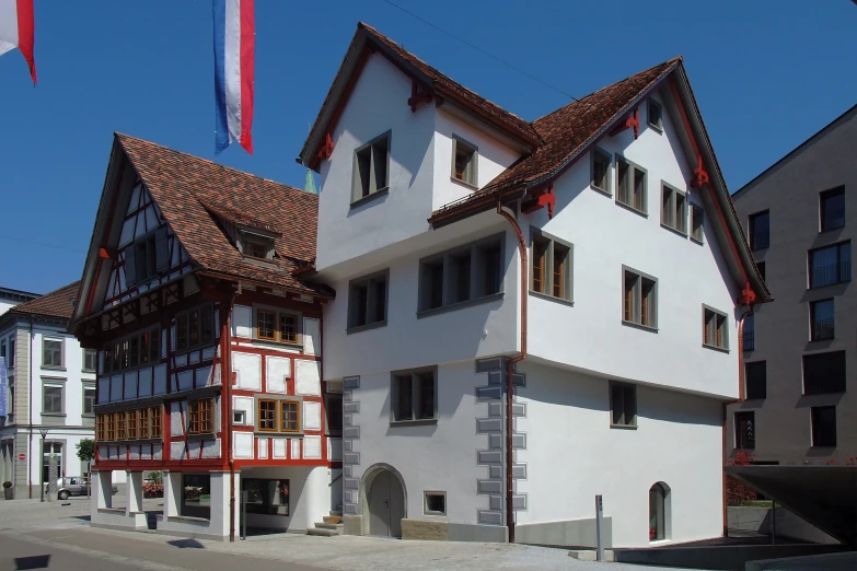 an old white and brown building with windows