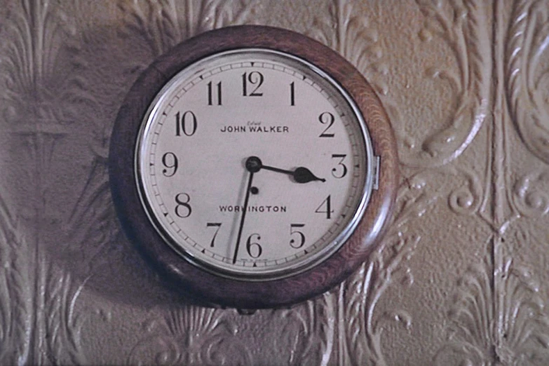 a clock is shown above a plastic wall