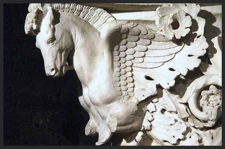 a white statue of a horse with wings on it