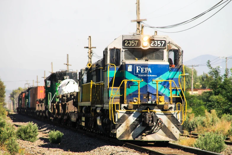 the engine and car of a train are moving on train tracks