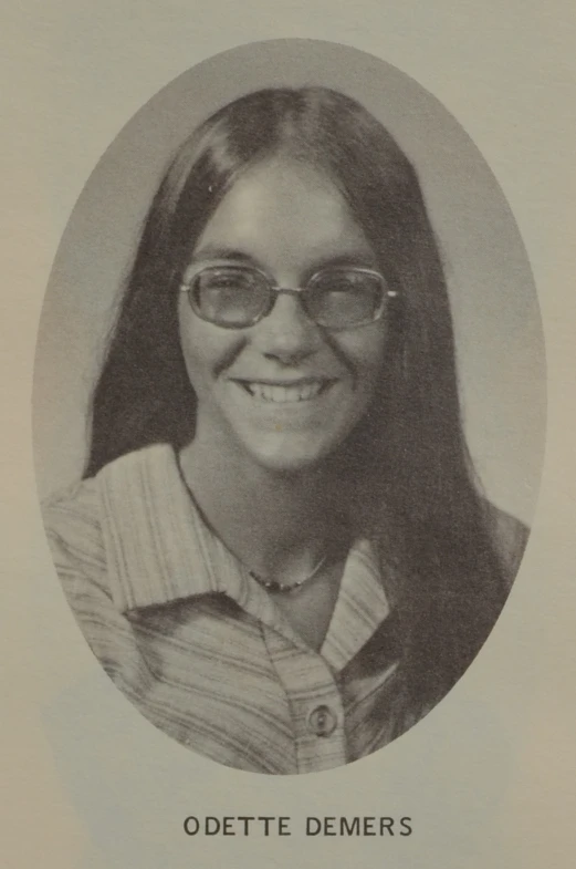 a person wearing glasses and a striped shirt