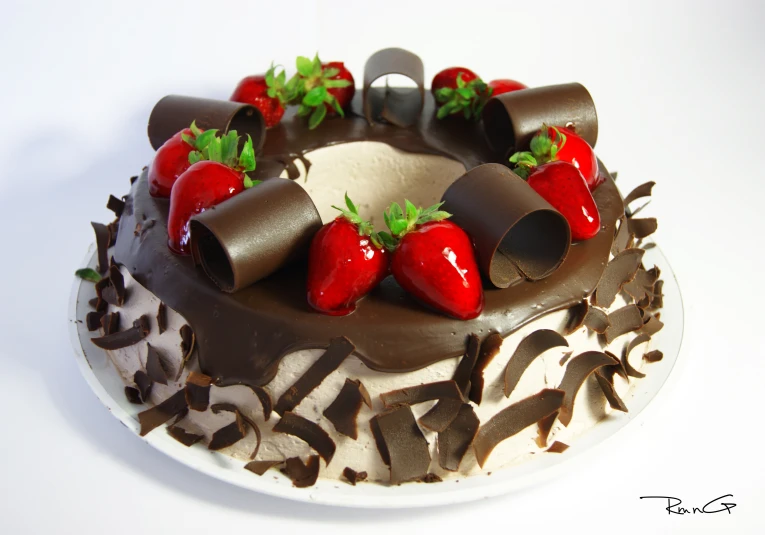 a cake with chocolate and strawberrys decorated on top