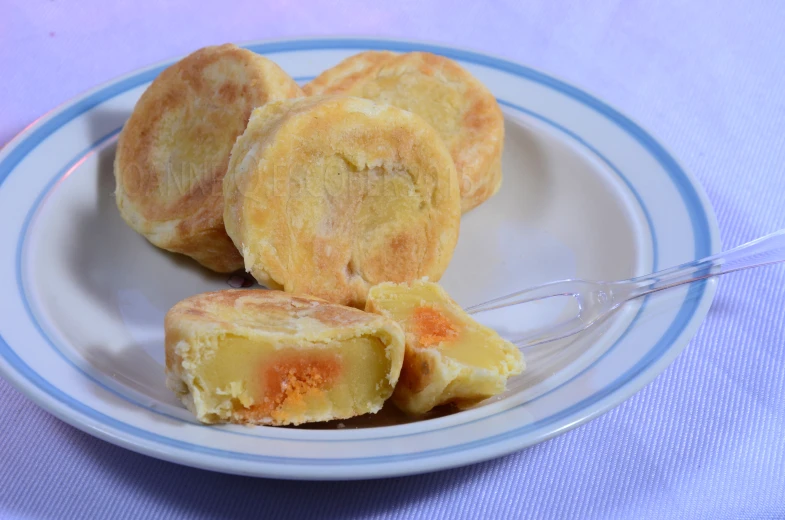 small pieces of bread on a plate next to a fork