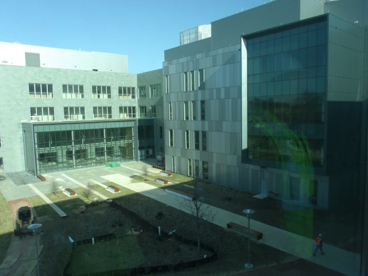an empty courtyard is seen from a large window