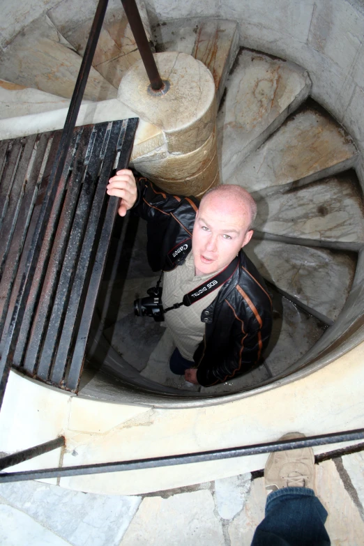 there is a man holding on to a metal handrail