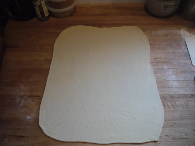 a dough is being rolled up on the floor