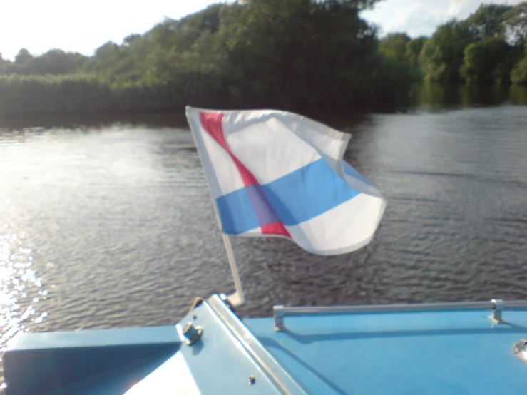 the flag is waving in a boat on the water