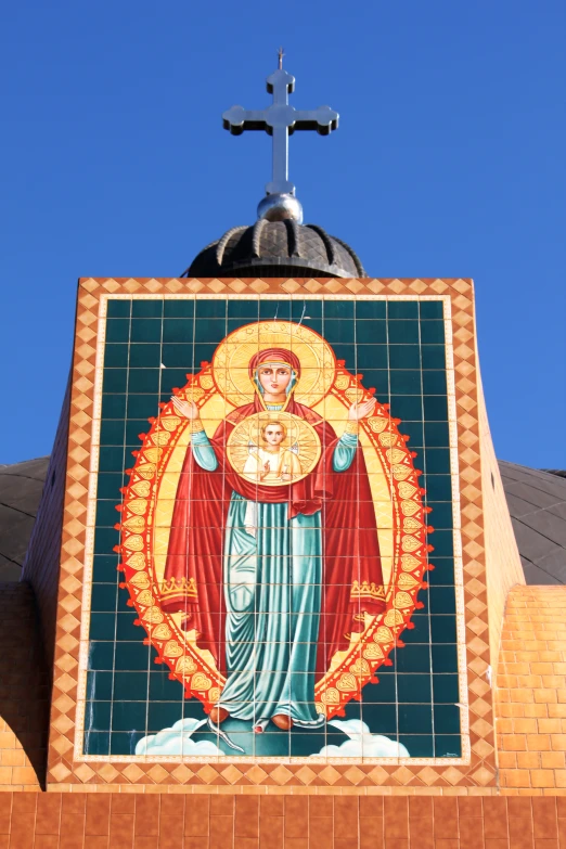 large tile mosaic with religious symbol on side