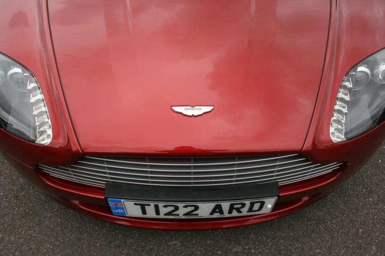 the front view of a red car with a white license plate