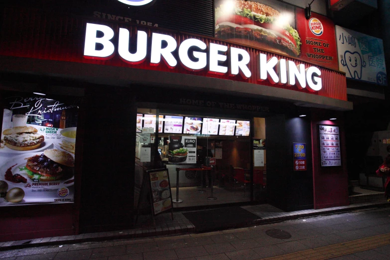 the outside of a restaurant with neon signage