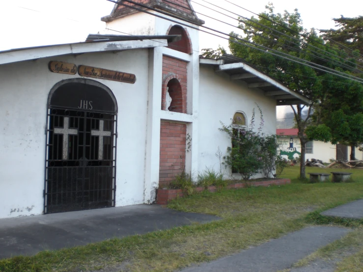 there is a church with a black door and a big cross on the front