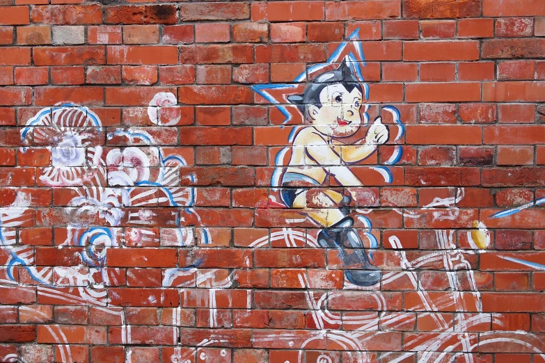 a painted brick wall showing a painting on a  riding a bike