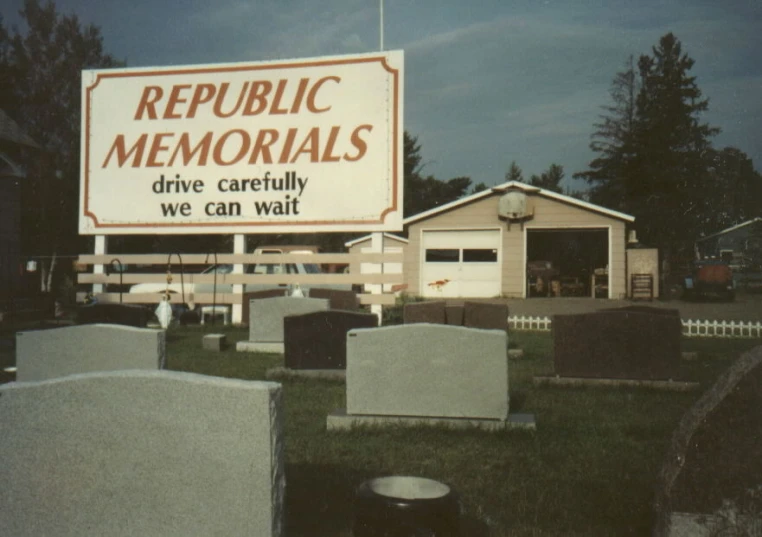 an old po of the cemetery with some large signs in front