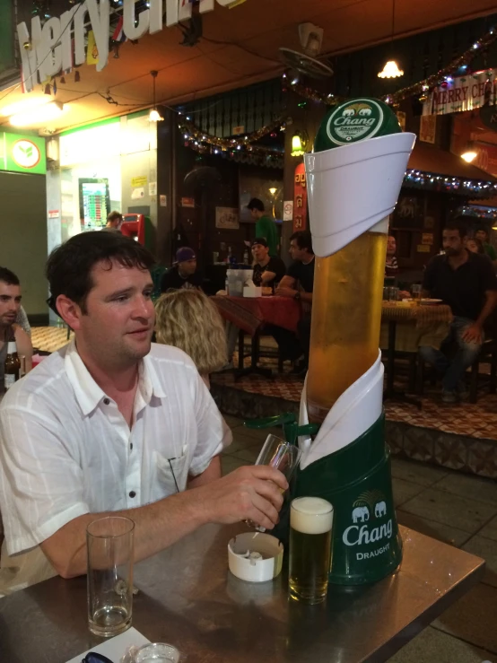 man sitting at the table near many glasses on the table