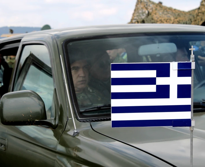 there is a car with a greek flag on the back