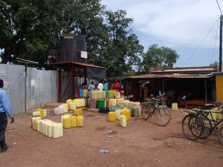 an image of an outdoor market scene with yellow containers