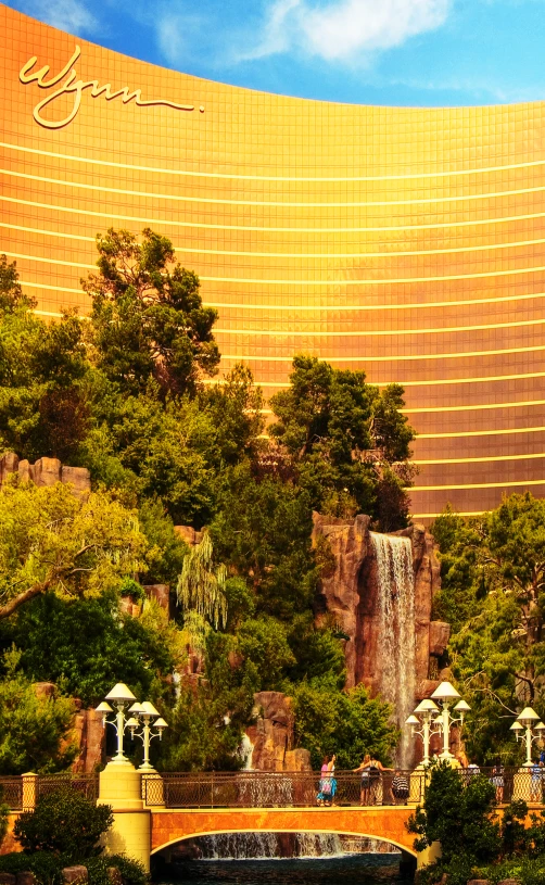 a tall building near a water fall and trees