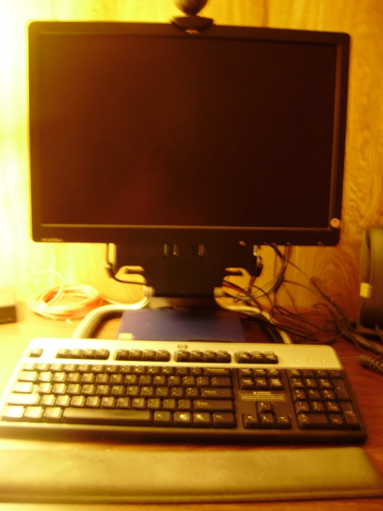 there is a monitor with keyboard and mouse on a desk