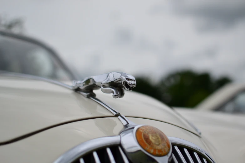 an image of some old style cars parked in a lot