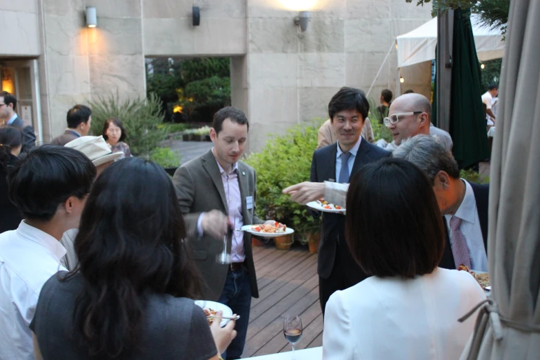 a man serves plates of food to a group