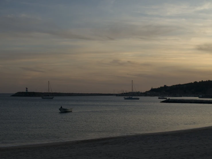 small boats anchored on the shore of an ocean