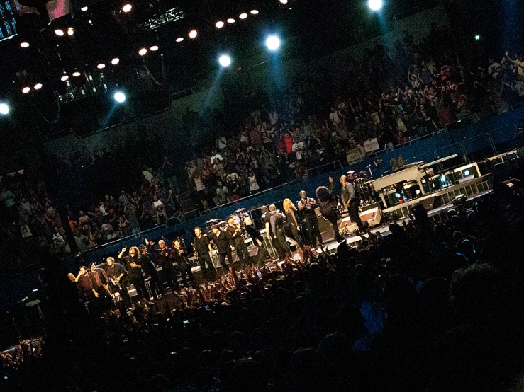 an image of orchestra performing on stage at the concert