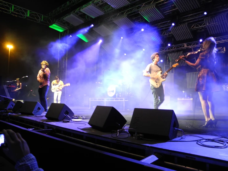 a band performs on stage at a concert