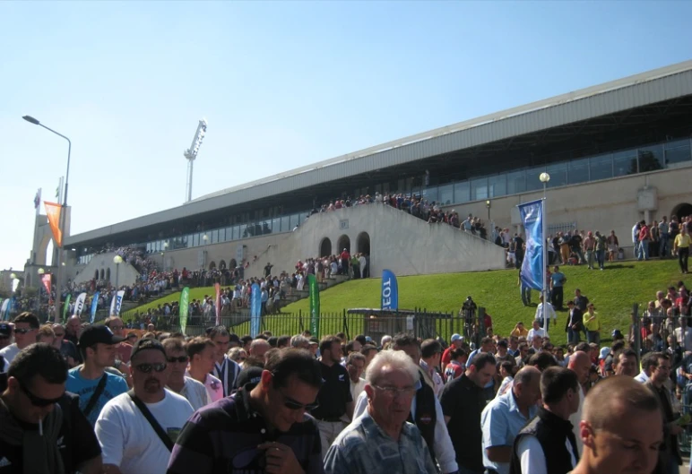 a crowd of people standing around a large building